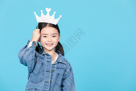 小女孩拿趣味小皇冠拍照背景图片