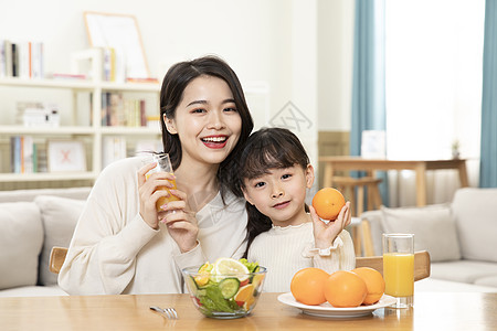 喝果汁的人母女居家生活喝橙汁背景