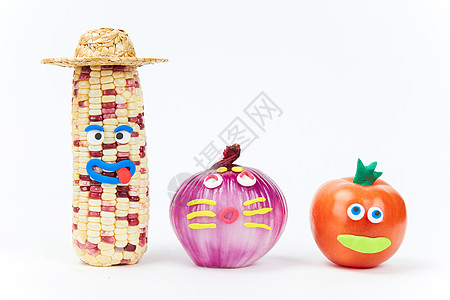 愚人节创意蔬菜玉米洋葱和西红柿背景图片