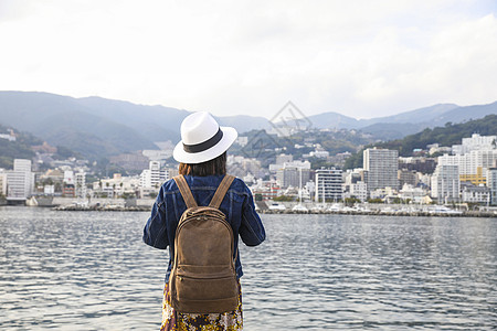 日本城市站在河边看风景的女人背影背景