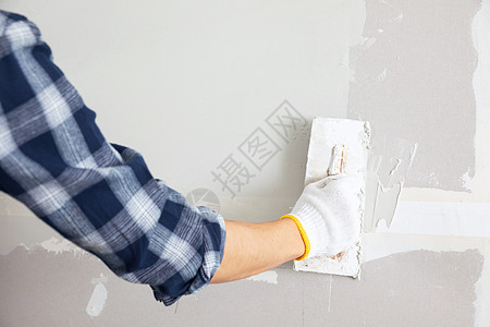 施工讨论装修工人擦墙腻子手部特写背景