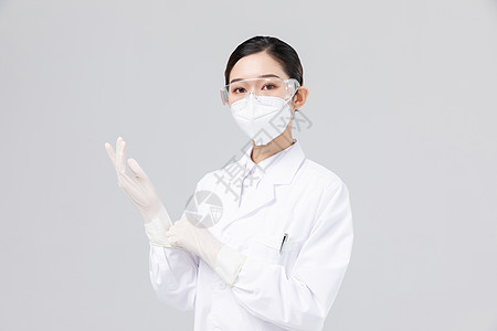 佩戴口罩与护目镜的女医生背景图片