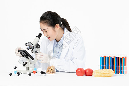 女性生物学家用显微镜检测食品安全背景图片