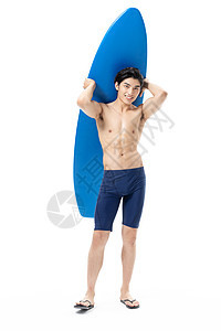 夏日泳装男性玩冲浪板图片