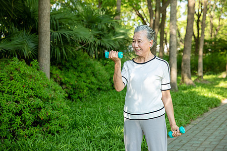 老年女性户外公园哑铃运动图片