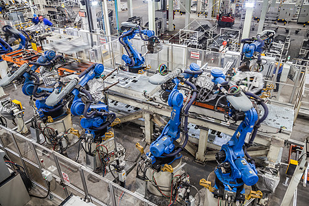 机器人汽车汽车生产车间机器人在焊接背景