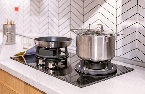 厨房用品素材厨房用品厨具不锈钢锅与燃气灶台背景