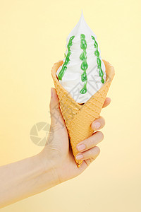 草莓味甜筒手拿抹茶味甜筒冰淇淋背景