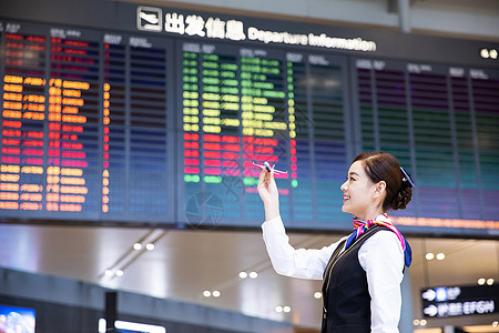 航空美女机场空姐拿飞机模型背景