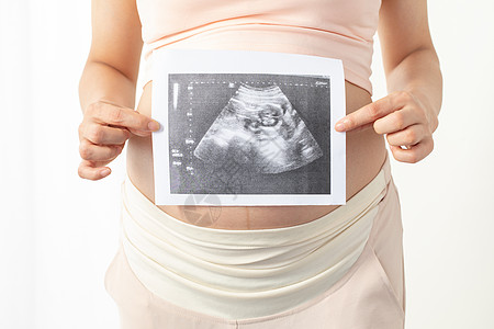 丝绸照片孕妇手拿宝宝b超照片背景