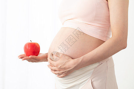 孕妇手拿苹果图片