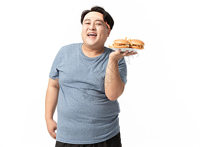 肥胖男士手拿汉堡高清图片