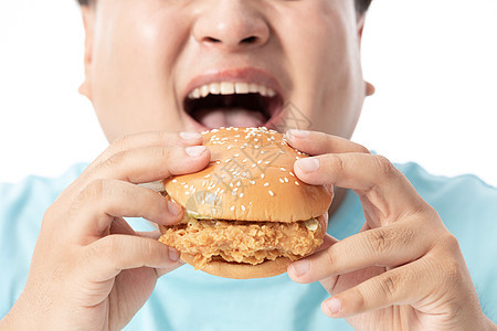 肥胖男士大口吃汉堡背景图片