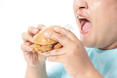 肥胖男士大口吃汉堡图片