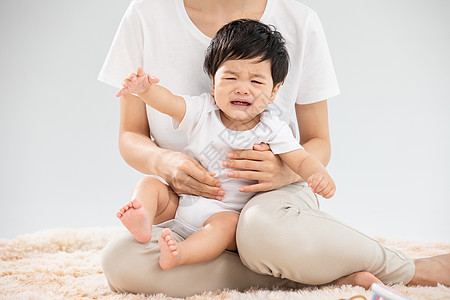 妈妈背孩子年轻妈妈带娃婴儿哭闹背景