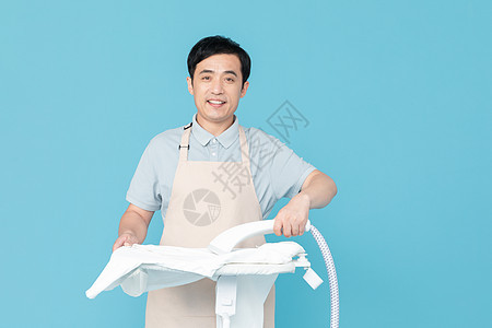 使用挂烫机熨烫衣服的家政服务男性图片