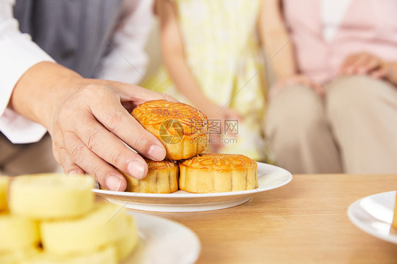 中秋节爷爷手拿月饼特写图片