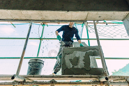 水泥外墙正在做外墙施工的建筑工人背景