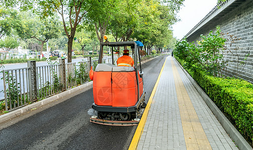 城市清洁车辆清洁马路背景图片