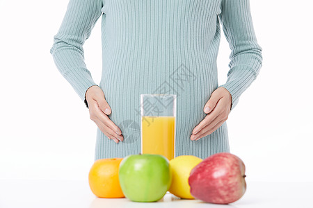 健康水果和孕妇肚子近景高清图片
