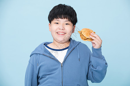 爱吃汉堡的男孩肥胖的小孩拿着食物图片