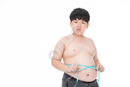 男孩用软尺测量腰围肥胖心情失落背景图片