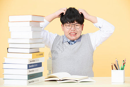 书眼镜笔面对作业发愁的小男孩背景