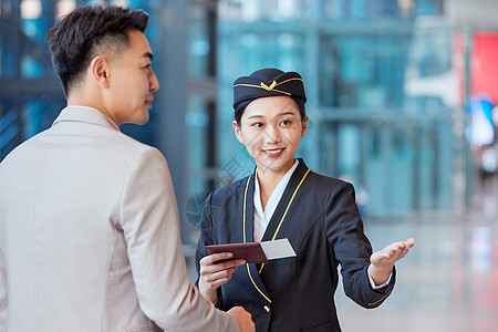 空姐向男性乘客指引服务背景