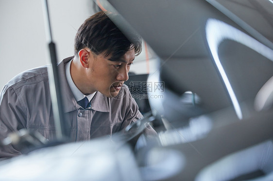 汽车修理工在检查发动机检查汽车汽修工侧脸图片