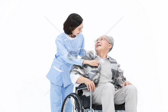 护士给轮椅上的老人披上披风图片