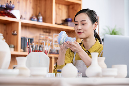 美女工匠绘制陶艺瓶图片