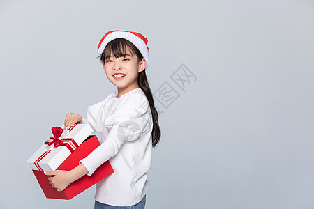 小孩圣诞礼物小女孩抱着圣诞礼物背景