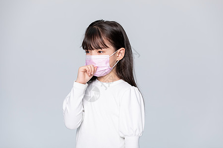 小女孩戴着口罩咳嗽背景图片