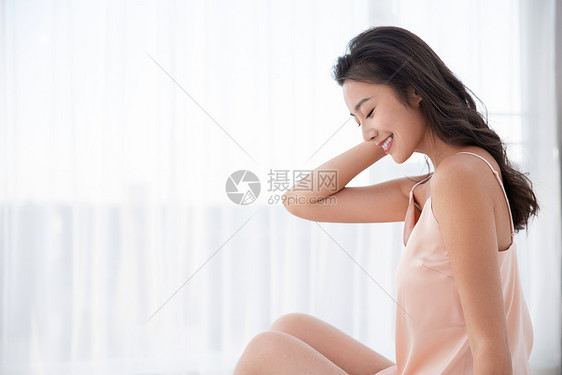 美女周末休闲度假坐在床上图片