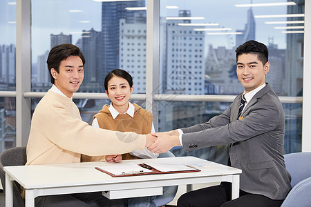 房产销售与客户握手洽谈合作图片