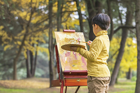 秋季儿童公园里拿调色盘绘画背景