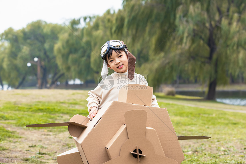 秋季小男孩抱着纸盒箱飞机嬉戏图片