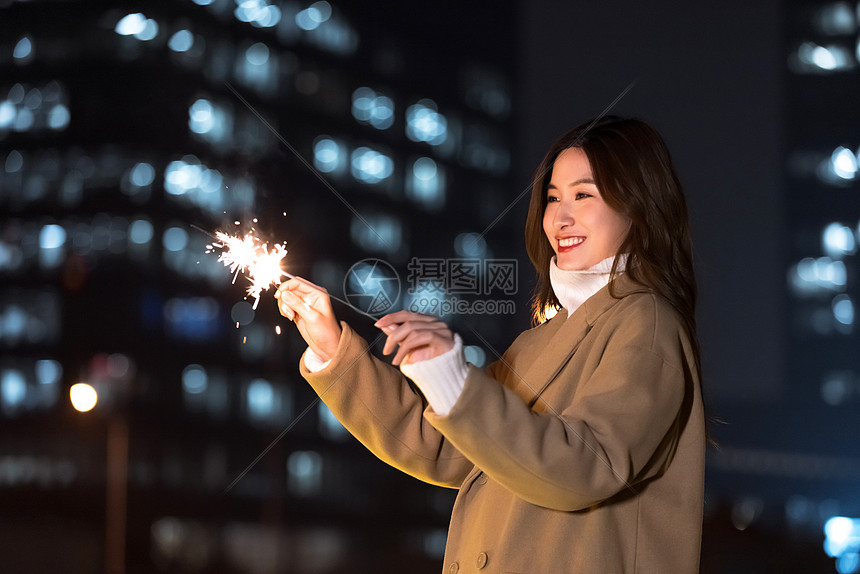 秋冬夜晚美女室外放烟花图片