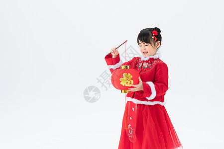 身穿喜庆红色古装提着灯笼的小女孩图片素材