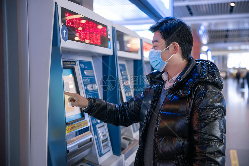 疫情期间在火车站购票的男性