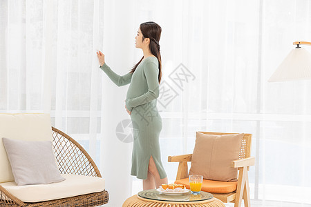 居家生活的孕妇抚摸肚子图片