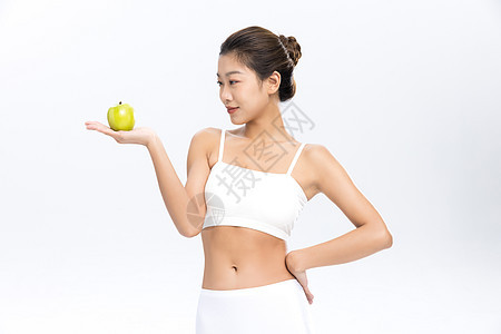 塑形塑身美女手拿苹果饮食管理图片