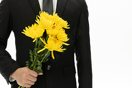盛开的小菊花商务男性拿着黄色菊花特写背景