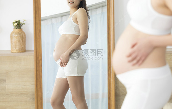 孕妇对着镜子看自己的身材图片