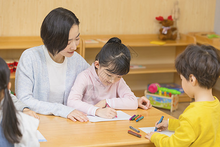 孩子识字幼儿园老师教小女孩写字背景