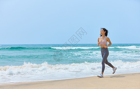 年轻美女海边运动跑步图片