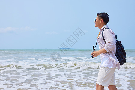 年轻男士海边旅游拍照图片