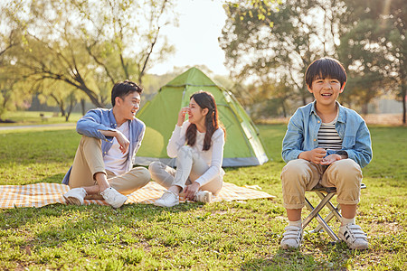 温馨一家三口一家三口公园草地上郊游背景