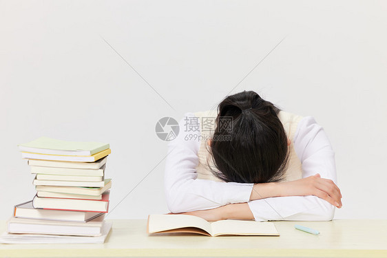 疲惫的学生趴在课桌前休息图片