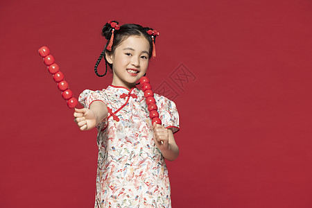 红色背景中国风旗袍儿童手拿冰糖葫芦图片